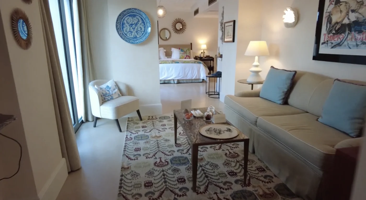 Villa Sant Andrea Taormina Suite Living Room Sicilian Plates Cream Sofa Patterned Rug Bedroom View