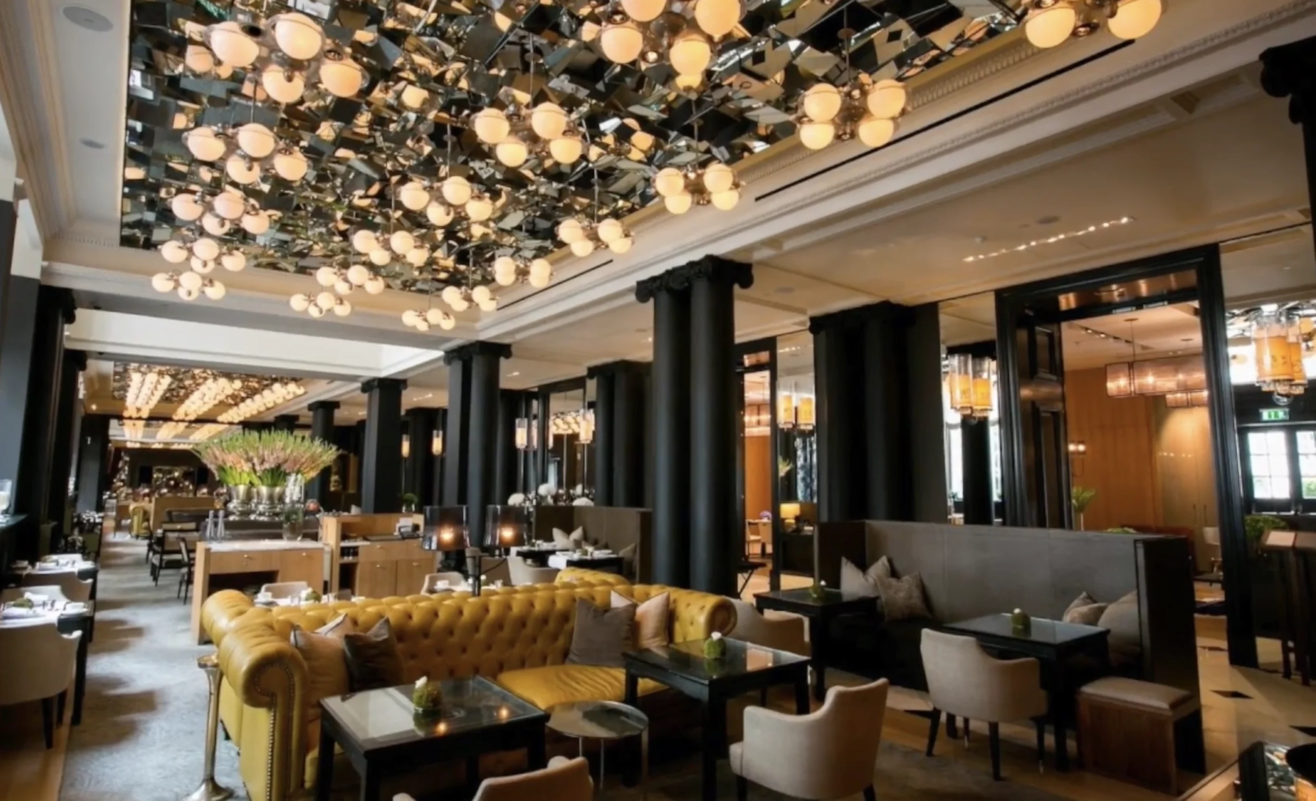 Holborn Dining Room at Rosewood London — reclaimed oak, antique mirrors and red leather banquettes