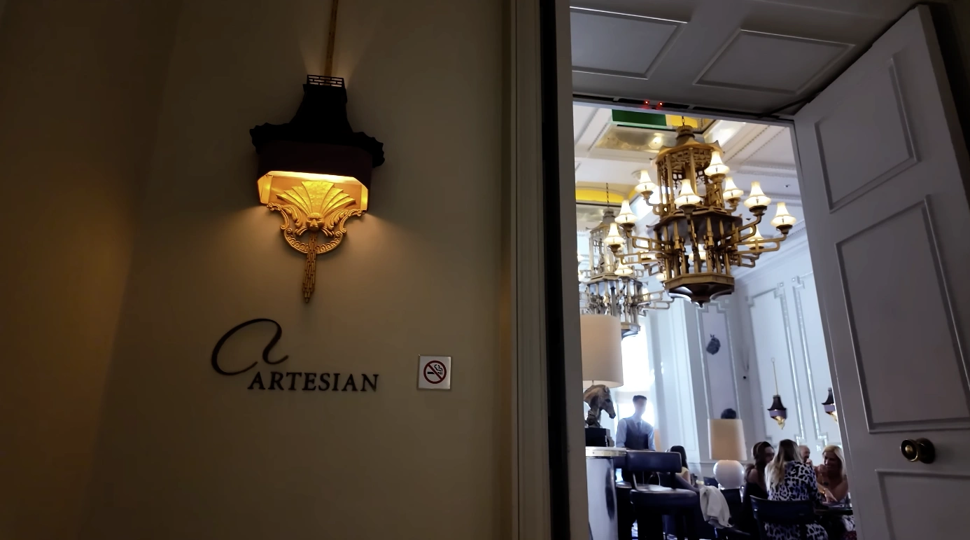Artesian Bar entrance at The Langham London — gold sconce and signage