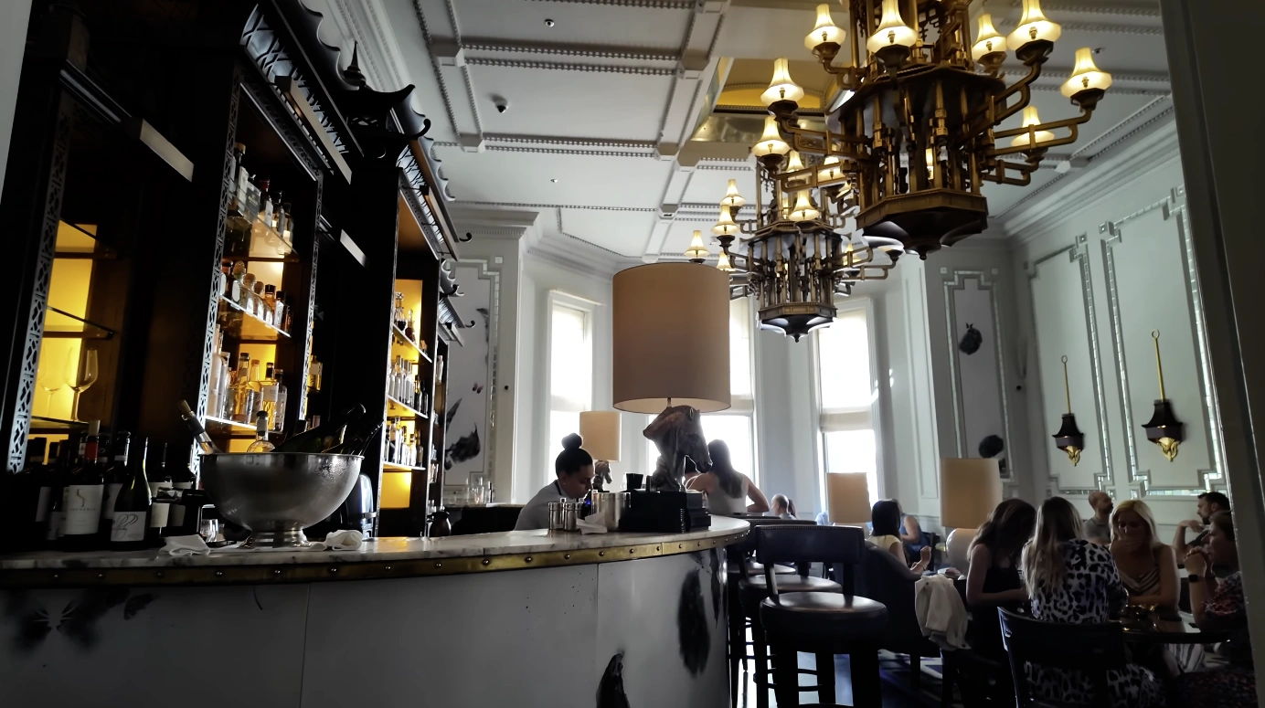 Artesian Bar at The Langham London — white counter and chandeliers interior