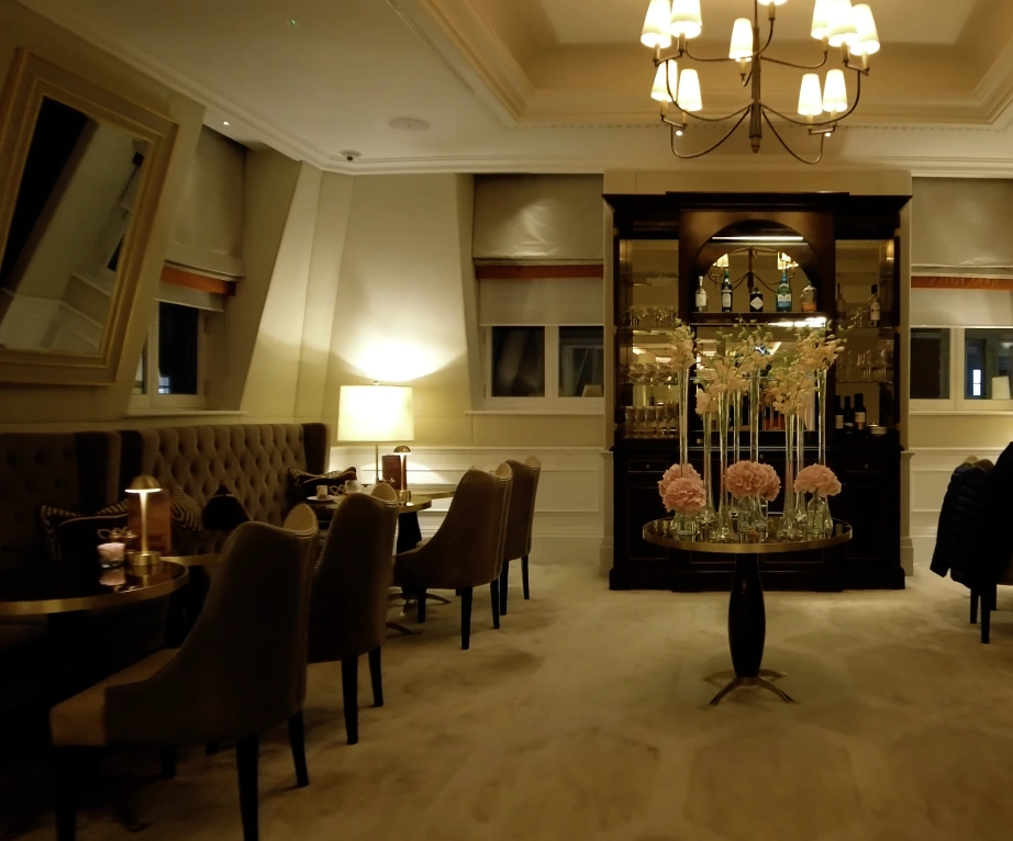 The Langham London — grand entrance with blue carpet and chandelier