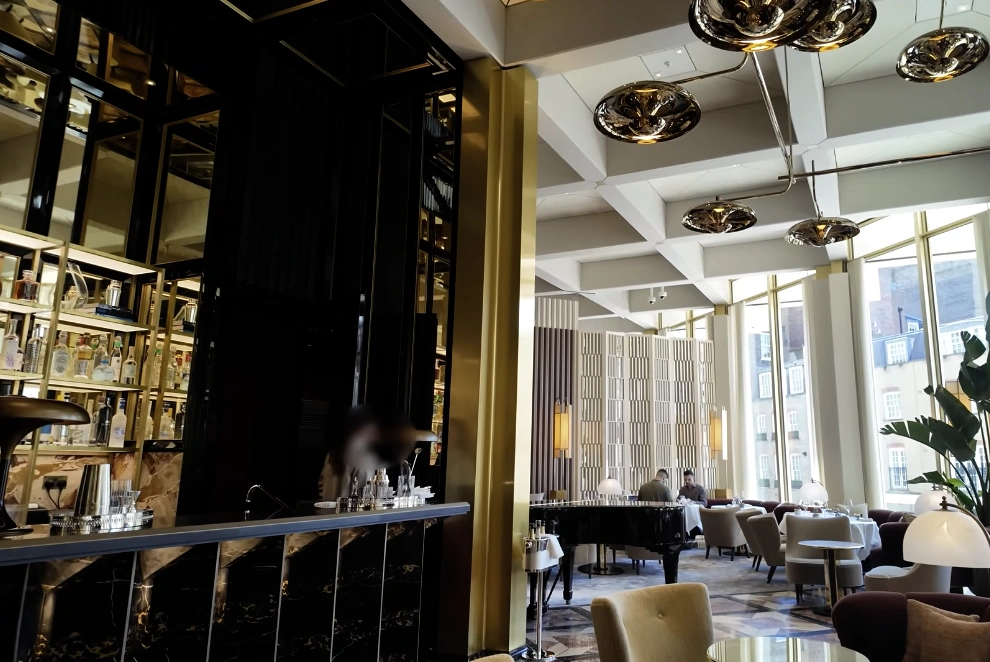 Carbone London at The Chancery Rosewood — bar and restaurant interior with grand piano and gold pendant lights