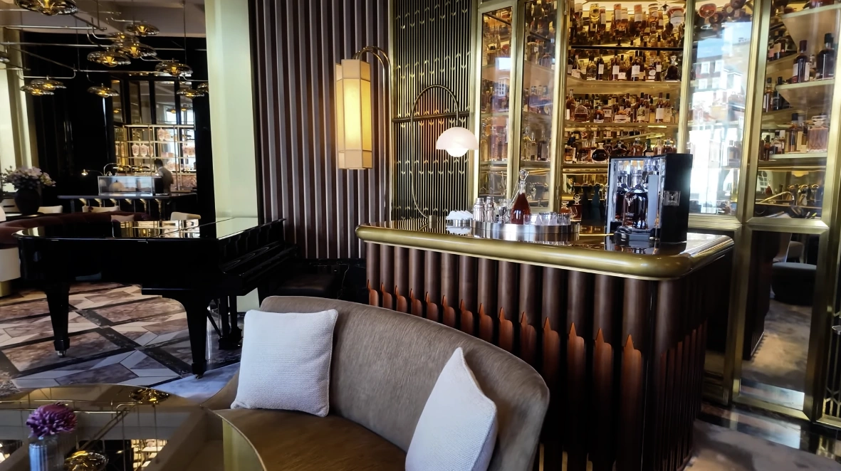 The Chancery Rosewood — cocktail bar with grand piano and floor-to-ceiling spirit display