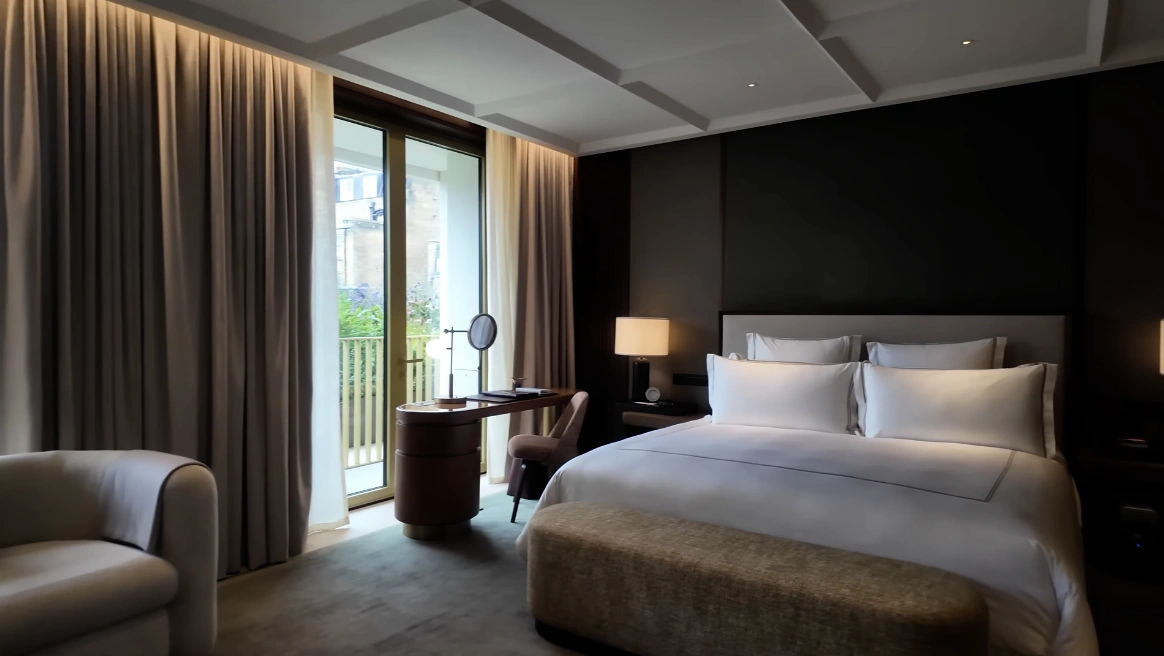 The Chancery Rosewood — guest room with king bed, dark feature wall and garden balcony