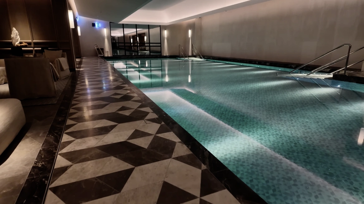 Asaya Spa at The Chancery Rosewood — 25-metre indoor pool with mosaic tiles and geometric marble surround