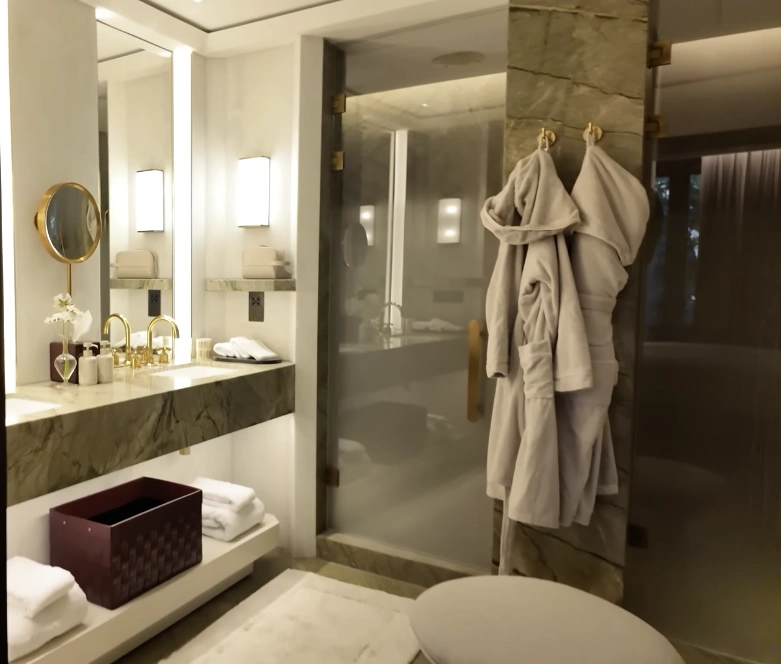 The Chancery Rosewood — marble bathroom with gold taps, bathrobes and glass shower