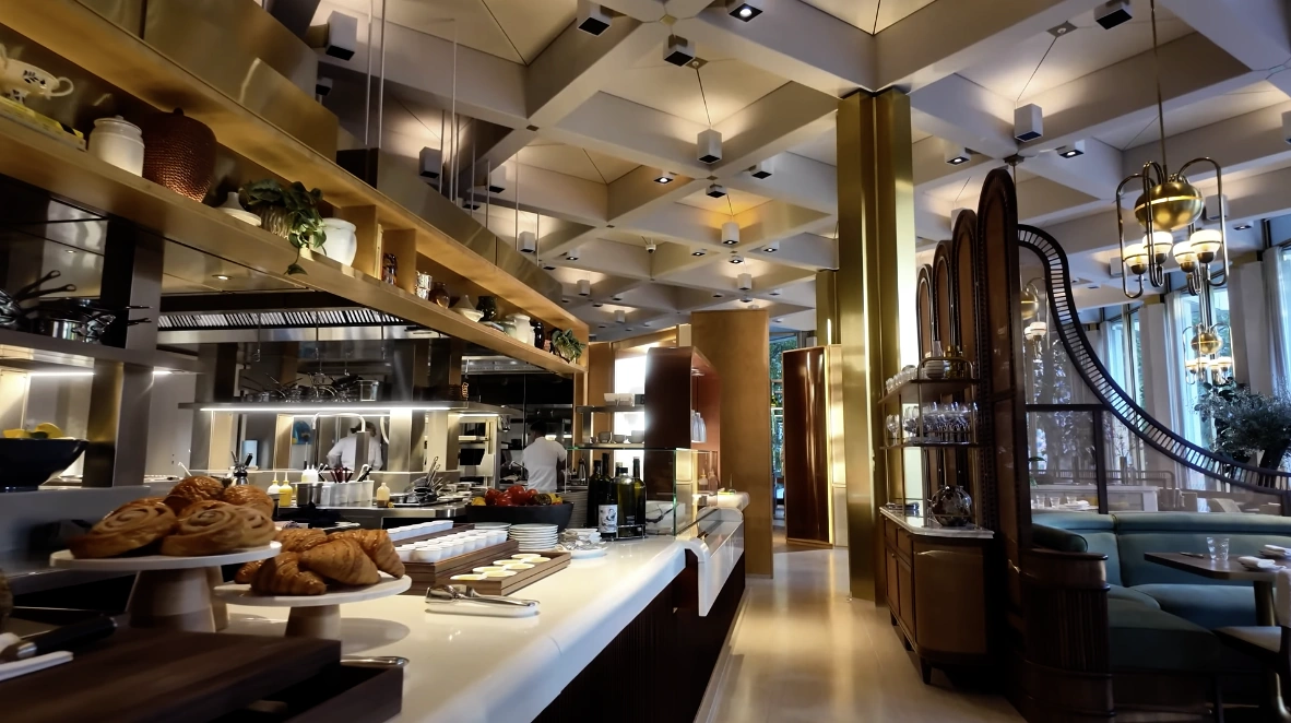The Chancery Rosewood — open kitchen buffet with pastries and chefs in gold-accented dining room