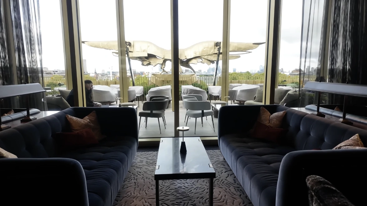 Eagle Bar at The Chancery Rosewood — rooftop lounge with blue velvet sofas and London skyline view