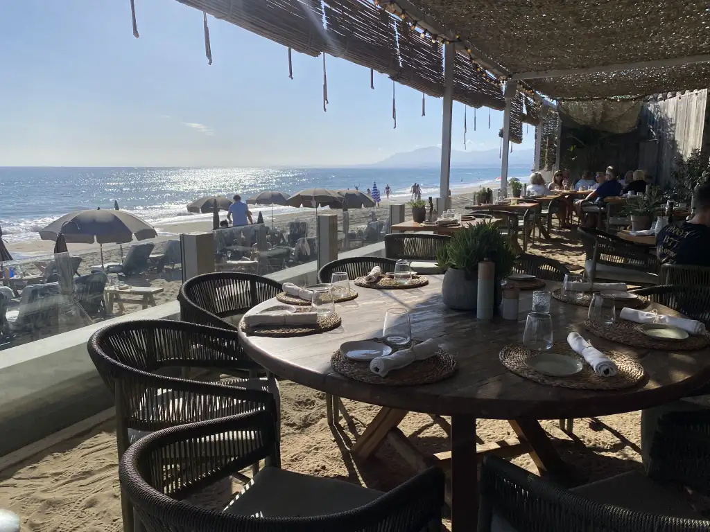 Luuma Beach Marbella sandy floor dining area at sunset El Rosario Playa Hermosa