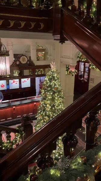 The Connaught Mayfair lobby decorated for Christmas with fireside seating