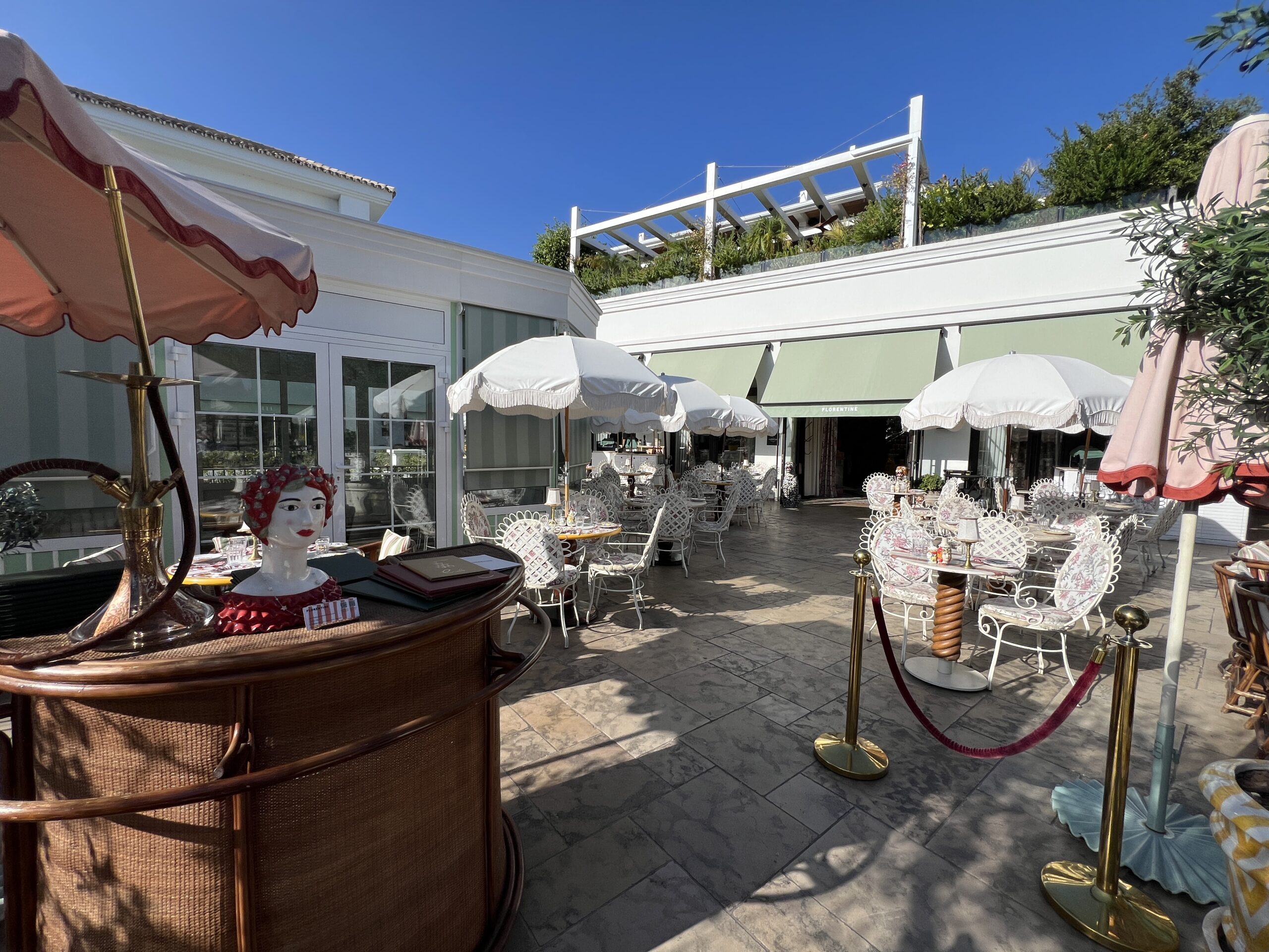 Florentine restaurant terrace with umbrellas at Forum Marbella