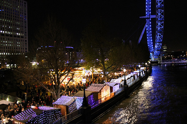 Southbank Centre Winter Market chalets beside the River Thames in London